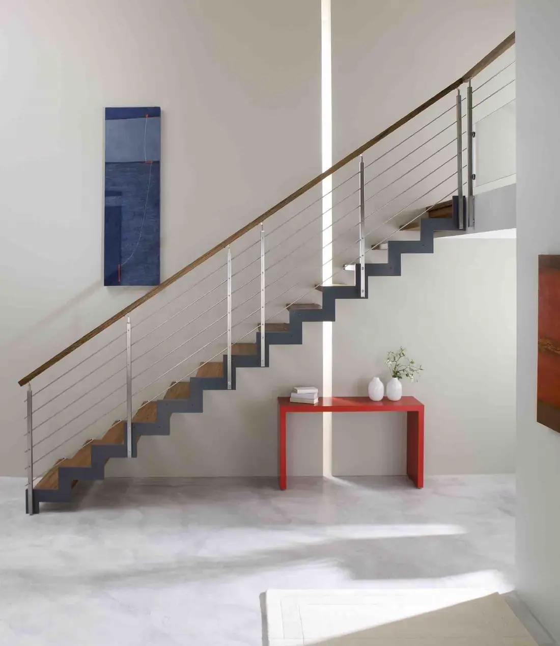 Escalier à limon acier anthracite central, marches en bois et main courante bois